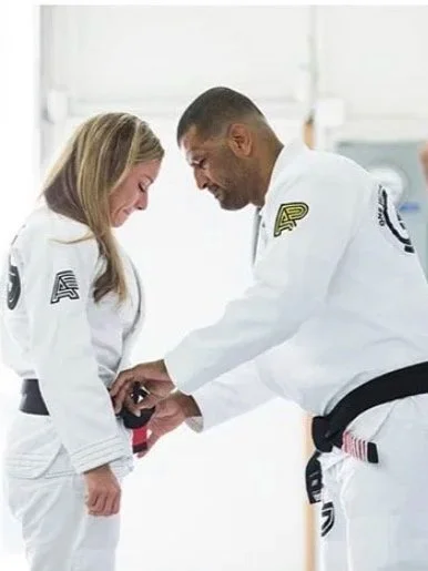 Erica receiving her Brazilian Jiu-Jitsu black belt from her coach