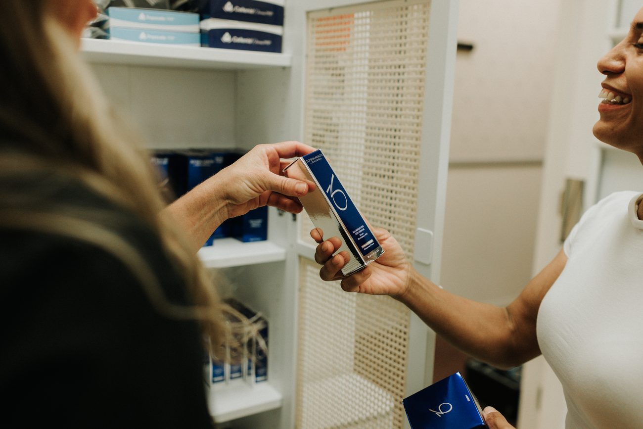 Erica Santana walking a client through a ZO Skin Health product at the retail shelf