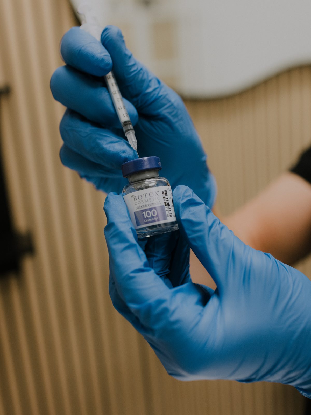 Drawing up a wrinkle relaxer from the vial before treatment